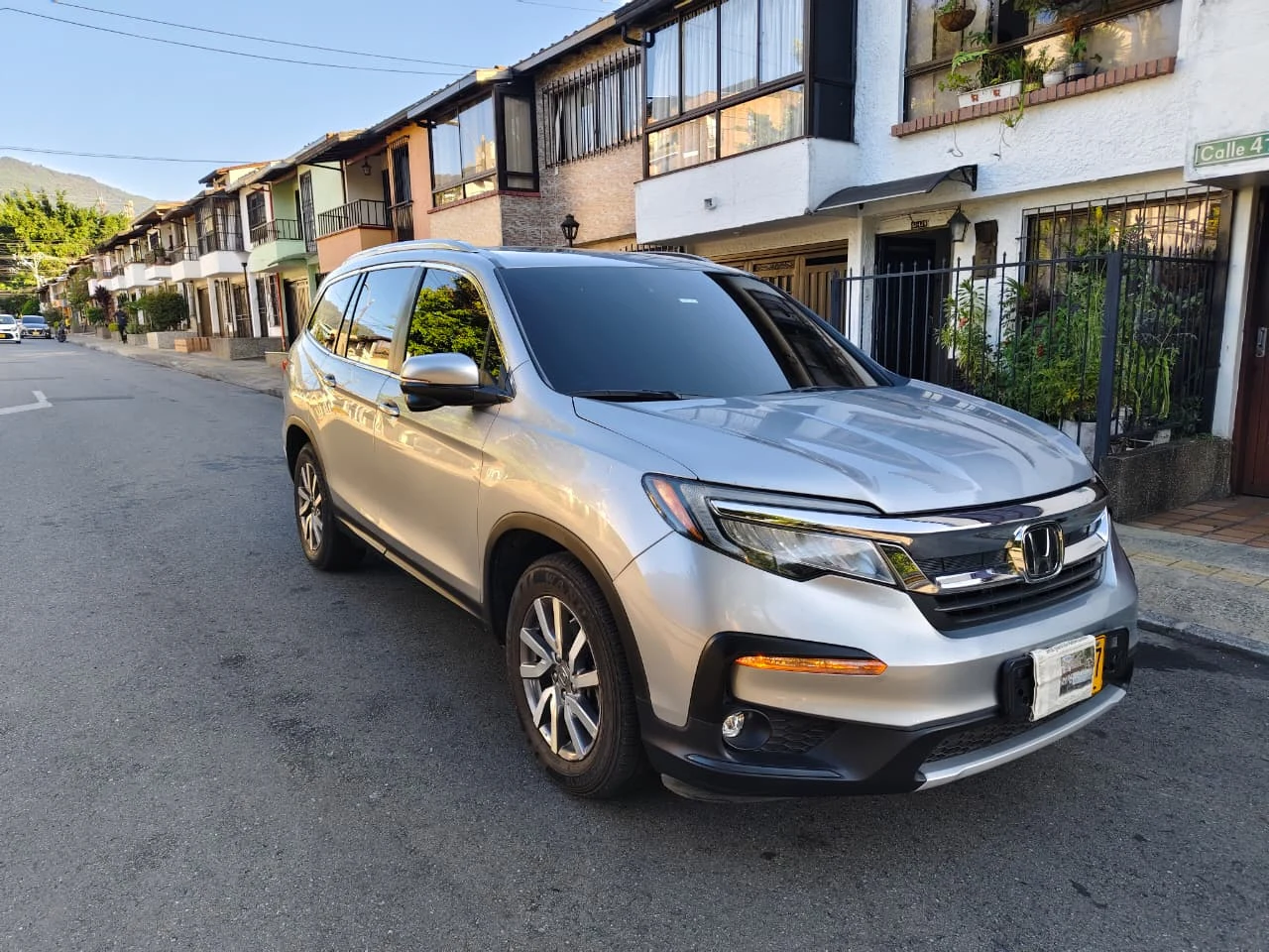 Honda Pilot color plata luna, vista delantera y lateral